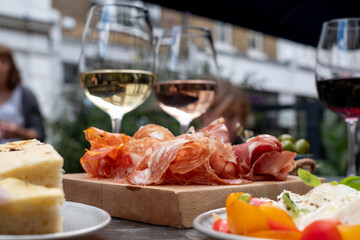 Appetising platters of caprese mozzarella cheese and tomatoes, and salami meat, photographed at a...