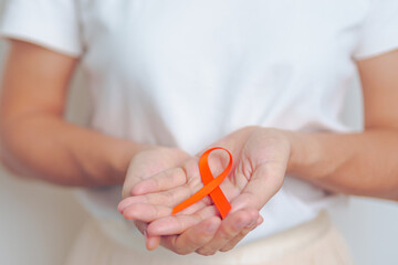 woman with Orange Ribbon for Leukemia, Kidney cancer day, world Multiple Sclerosis, CRPS, Self...