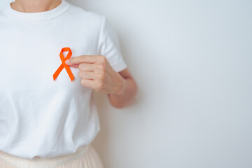 woman with Orange Ribbon for Leukemia, Kidney cancer day, world Multiple Sclerosis, CRPS, Self...