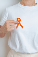 woman with Orange Ribbon for Leukemia, Kidney cancer day, world Multiple Sclerosis, CRPS, Self...