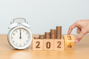 Happy New Year with vintage alarm clock and flipping 2023 change to 2024 block. Resolution, Goals,...
