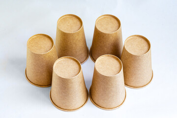 Stack of paper mugs. Six disposable paper cups made of cardboard kraft paper.