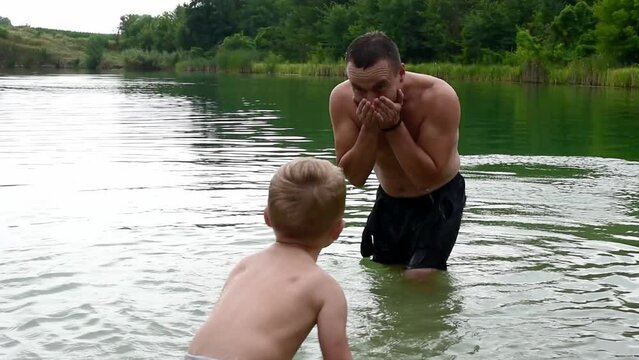 Summer leisure time , father with kid son splashing in water and have fun, water games. Family relationships ,horizontal 4k footage