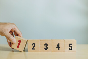 A man hand place wooden cubes with number one. Priority of activities. Concept of task priority and...