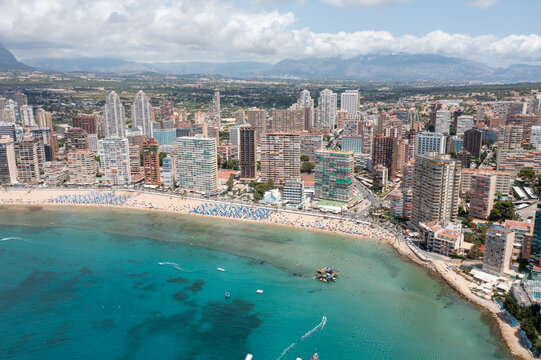 Aerial drone photo of the beautiful city of Benidorm in Spain in the summer time showing the Playa de Levante beach and the high rise apartments and hotels in the city in the summer time