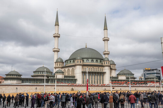 Istanbul, Turkey - 23 April 2023: View of a a group of people standing at Taksim square with Taskim mosque for Erdogan election in Istanbul.