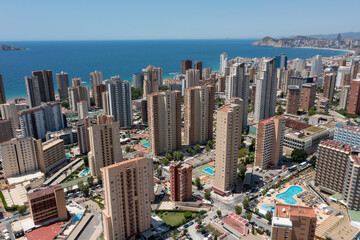 Fototapeta na wymiar Aerial drone photo of the beautiful city of Benidorm in Spain in the summer time showing the Playa de Levante beach and the high rise apartments and hotels in the city in the summer time