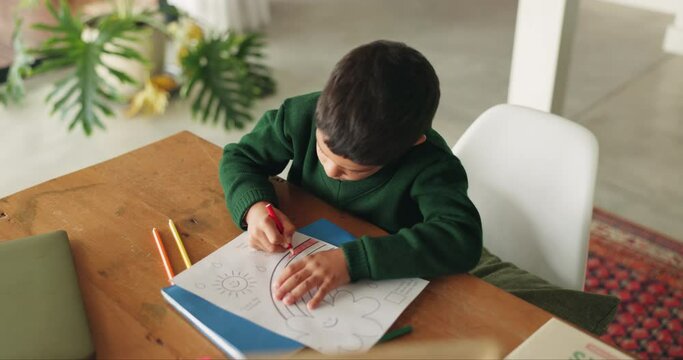 Creative, boy and home with kindergarten education, learning and color for development. Book, school homework and child above with student growth and drawing in a house with paper and illustration