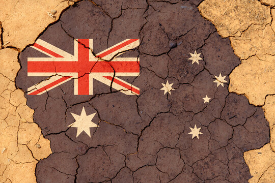 Drought. On Dry, Cracked Ground, The Image Of The Flag Of Australia.