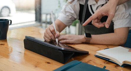 Close up of startup successful small business owner woman and man with business discussion in coffee shop restaurant. entrepreneur seller business delivery concept