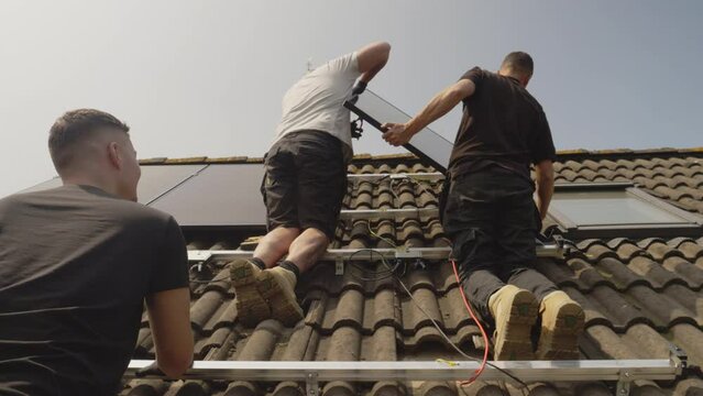 MS LA Technicians fitting solar photo voltaic panels to house roof
