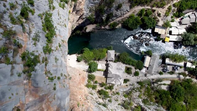 Aerial drone view of Tekija in Blagaj and source of Buna river. Tekke is historical dervish house. Cliffs above tekke in Bosnia and Herzegovina.