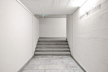 Large public building interior hallway or corridor with stairs or stairway, no people