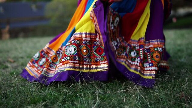 A Woman Picking Up Dandiya Sticks For Garba Gujarati Dance In The Garden Of Sydney Australia. Close up