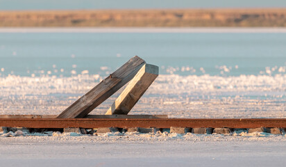 view of salt lake at sunset and abandoned green tracks