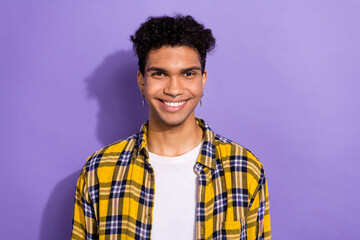 Portrait of positive funny nice man with afro hairstyle wear plaid shirt toothy smiling at camera isolated on violet color background