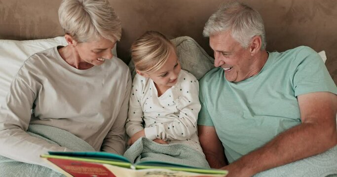 Bedroom, book and grandparents reading to a grandchild while in their home to relax together at a sleepover. Love, children and storytelling with a girl in bed, bonding with granny and grandpa