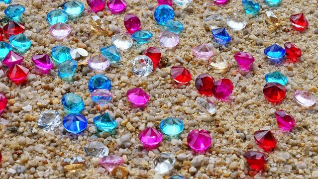 Colorful diamonds scattered on the beach The sun glistened off the facets of the precious stones, .creating a beautiful contrast with the white sand.colorful gemstones on the beach ..