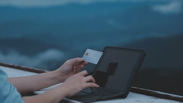 online payment, young woman holding credit card and typing on laptop