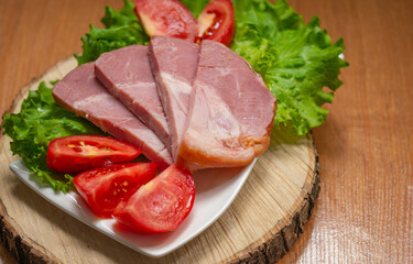 meat with herbs and tomato slices on a platter