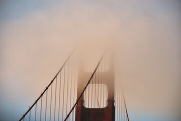 view of the top of golden gate bridge with fog