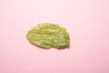 Skin scrub smear on pink background. Cosmetic product. Cleansing and exfoliating your skin