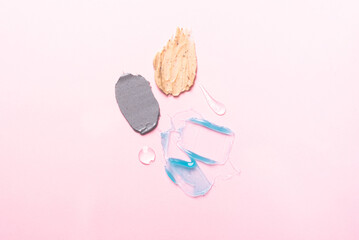 Cosmetic samples texture. Multicolored smears on a pink background