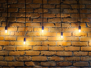Old brick wall with light bulbs 