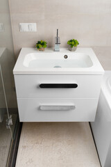 Washbasin and chrome faucet in the bathroom