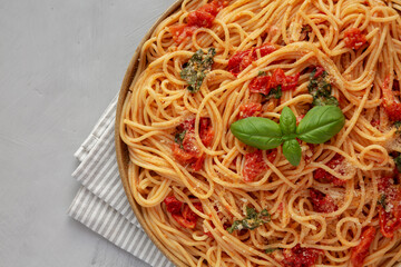Homemade Spaghetti With Fresh Tomato Sauce on a Plate, top view. Flat lay, from above, overhead. Copy space.