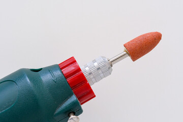 Mini Drill or Electric rotary tool plugged with grinding head