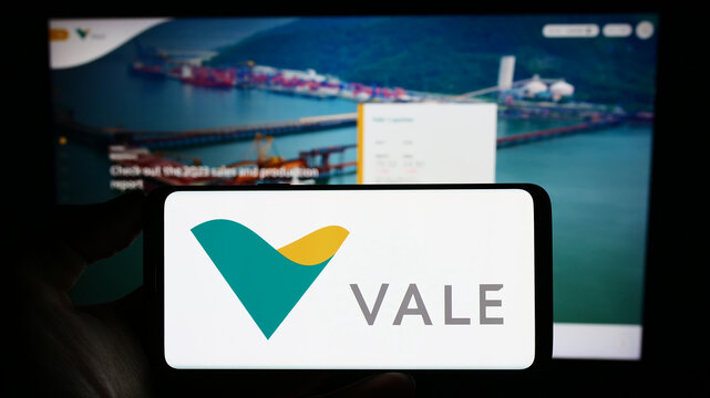 Stuttgart, Germany - 07-27-2023: Person holding mobile phone with logo of Brazilian mining company Vale S.A. on screen in front of business web page. Focus on phone display.