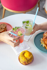 Iced mocktails in a plastic cup in a restaurant environment.