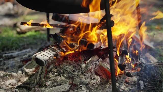Light a fire for cooking in a cauldron