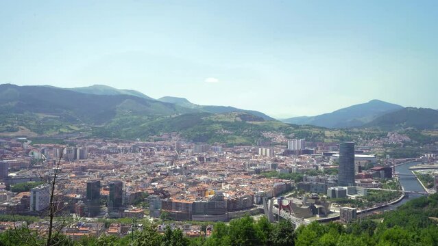 Panoramic view of Bilbao city. Perspective from above of the city. In front the old town and the river Nervion, in background the mountains that surrounding the city. Foggy day Stabilized static video