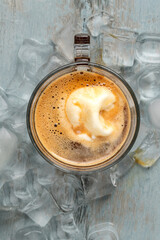 Affogato coffee with vanilla ice cream in a glass cup on wooden table