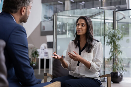 Businesswoman interviewing businessman in a corporate office
