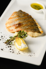 Appetizing grilled dorado fish fillet on a white plate