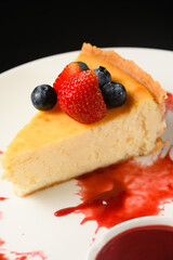 Appetizing dessert cheesecake on a white plate.