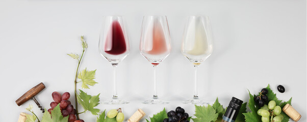 Banner. Flat-lay of red, rose and white wine in glasses on white background