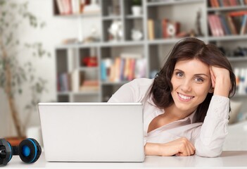 Young happy business woman worker working on laptop.