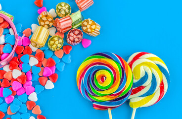 Colorful lollipops and different colored round candy. Top view.