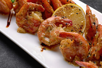 Fried shrimps in garlic sauce with lemon. Close up
