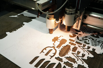 The process of milling machine cnc, CNC cutting pattern on plastic sheet, machine works operation in furniture production line. Industrial manufacturing.