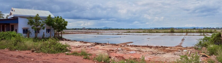 Salt pans and rural house in Kampot, Cambodia
