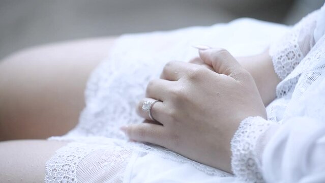 The bride's engagement ring is a cherished symbol of love and commitment that holds a special place in her heart, reminding her of the moment her partner asked her to be their spouse. 