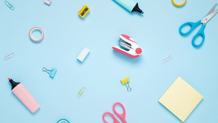 Set of stationery for work and study on blue background. Back to school. Top view, flat lay, copy space