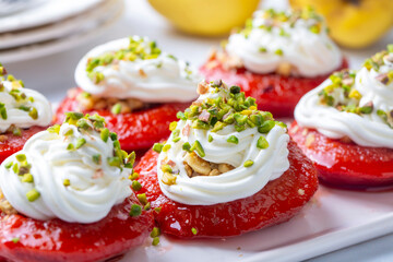 Traditional Turkish style quince dessert. The quince is cooked until soft, sherbet is poured on it, and served with cream and walnuts. It is one of the most popular Turkish desserts.(Ayva Tatlisi)