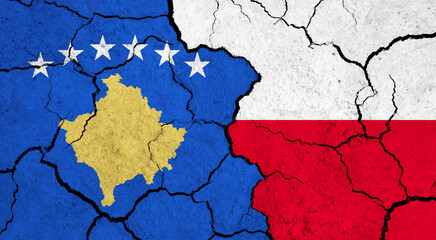 Flags of Kosovo and Poland on cracked surface - politics, relationship concept