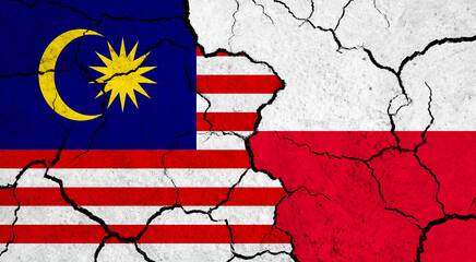 Flags of Malaysia and Poland on cracked surface - politics, relationship concept